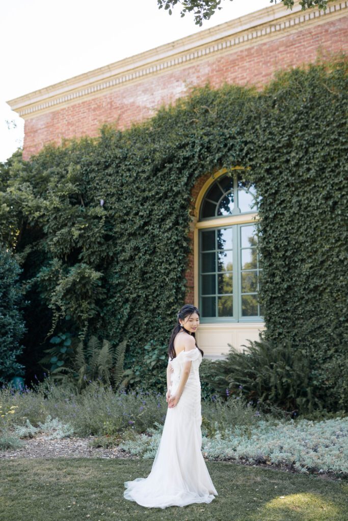 Discover the timeless beauty of a wedding at Filoli Gardens in California, expertly captured by Alyssa Gayle Photography. This enchanting photo showcases a joyful couple against the stunning backdrop of Filoli's historic architecture and lush greenery, embodying elegance and romance. Perfect for those seeking inspiration for a garden wedding venue.