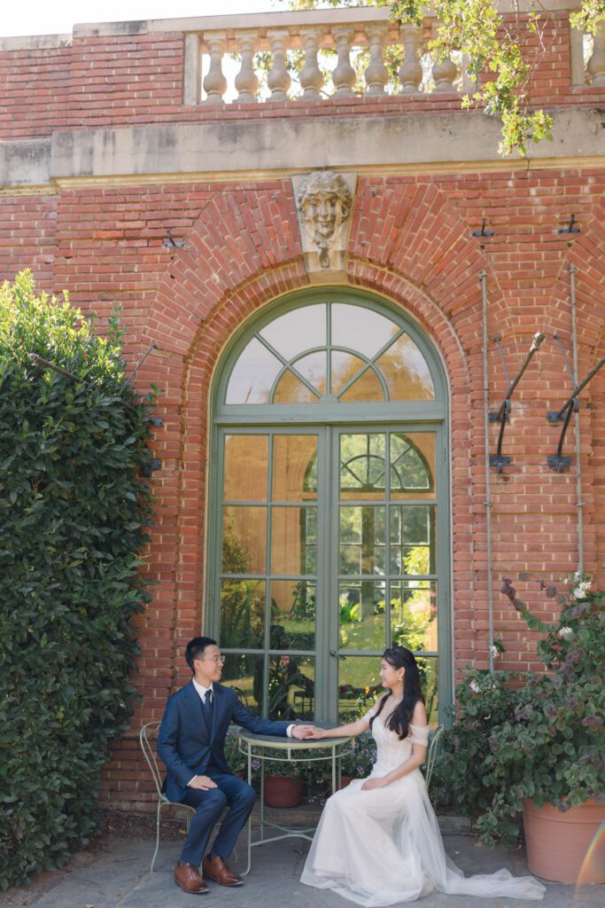 Discover the timeless beauty of a wedding at Filoli Gardens in California, expertly captured by Alyssa Gayle Photography. This enchanting photo showcases a joyful couple against the stunning backdrop of Filoli's historic architecture and lush greenery, embodying elegance and romance. Perfect for those seeking inspiration for a garden wedding venue.