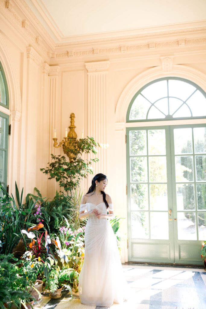 Discover the timeless beauty of a wedding at Filoli Gardens in California, expertly captured by Alyssa Gayle Photography. This enchanting photo showcases a joyful couple against the stunning backdrop of Filoli's historic architecture and lush greenery, embodying elegance and romance. Perfect for those seeking inspiration for a garden wedding venue.