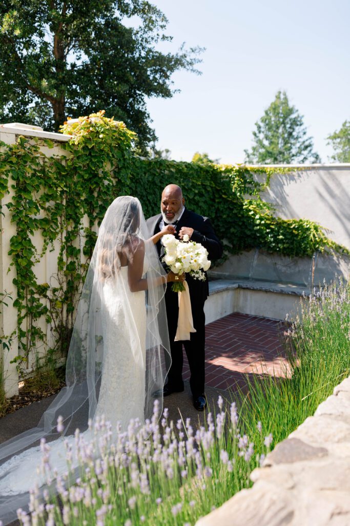 A serene outdoor ceremony space at MacArthur Place, featuring a vine-covered pergola and elegant floral arrangements.