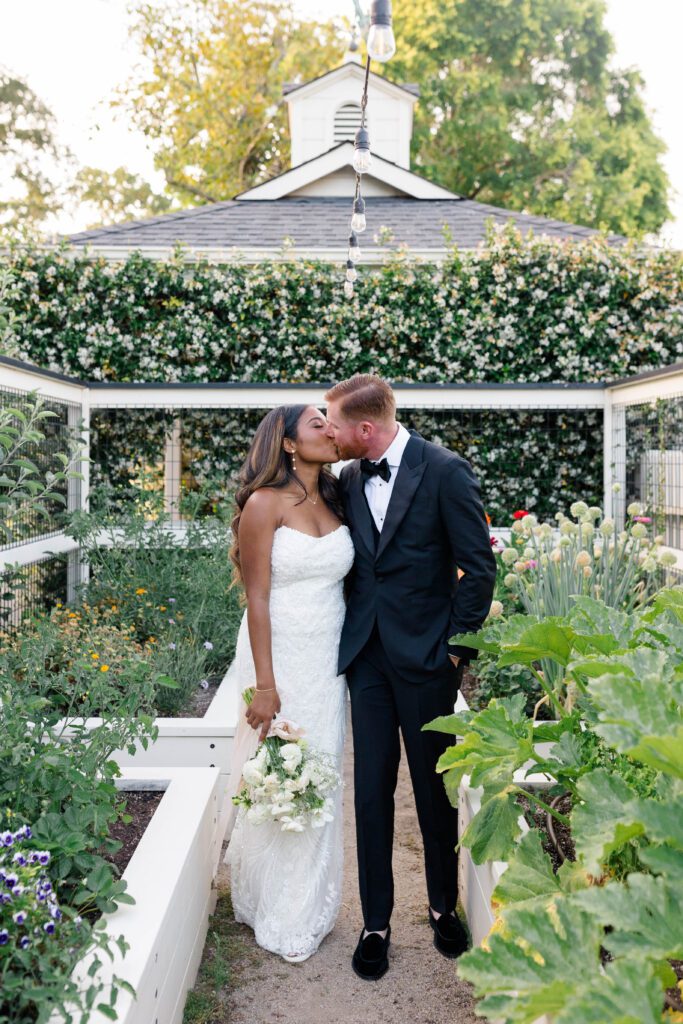 A verdant courtyard with flowering plants and cozy seating areas, perfect for relaxation and photos.