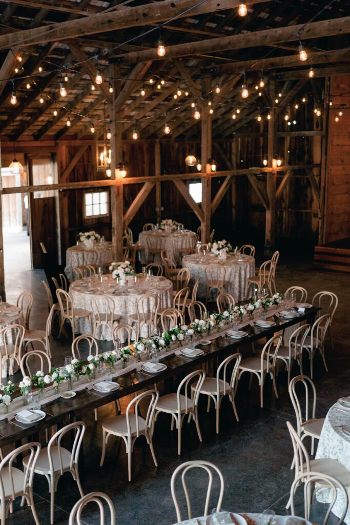 table scapes and details of the reception space, white florals and greens with overhead lighting and pattern table cloths olympias valley estate in petaluma california, wedding photography by alyssa gayle photography based in san francisco california and traveling worldwide