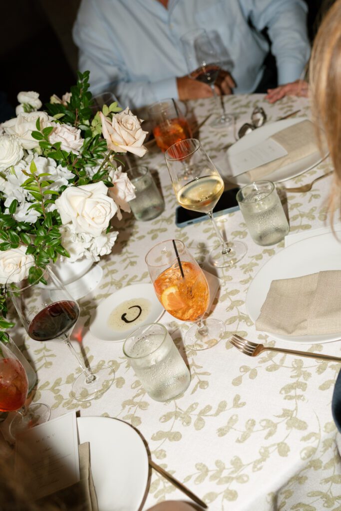 table scapes and details of the reception space, white florals and greens with overhead lighting and pattern table cloths olympias valley estate in petaluma california, wedding photography by alyssa gayle photography based in san francisco california and traveling worldwide