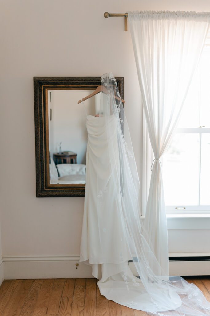 wedding dress hanging on mirror indoors the old vintage home olympias valley estate in petaluma california, wedding photography by alyssa gayle photography based in san francisco california and traveling worldwide