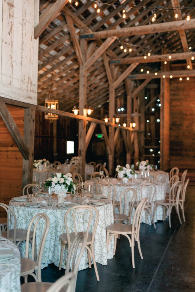 table scapes and details of the reception space, white florals and greens with overhead lighting and pattern table cloths olympias valley estate in petaluma california, wedding photography by alyssa gayle photography based in san francisco california and traveling worldwide