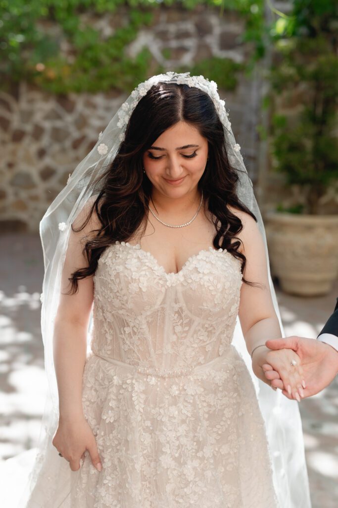 Bride wearing lace wedding dress during spring wedding at Jacuzzi Winery in Sonoma
