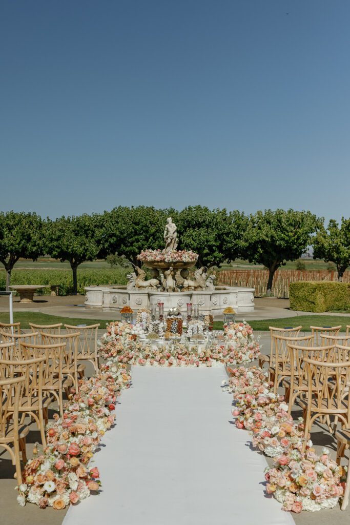 Outdoor wedding ceremony setup at Jacuzzi Winery in Sonoma with floral lined aisle

