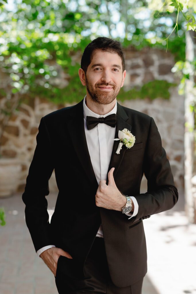 Groom wearing a black tuxedo during spring wedding at Jacuzzi Winery in Sonoma
