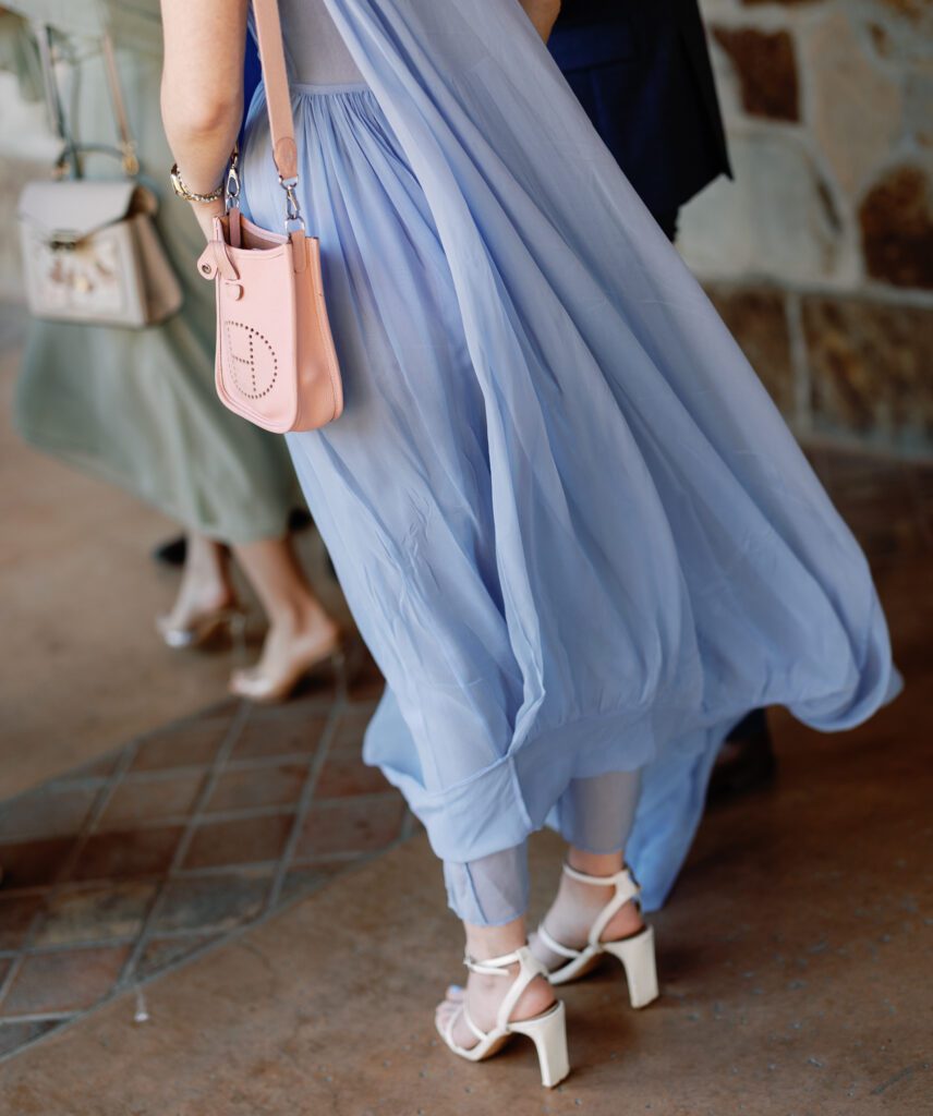 Wedding guest wearing blue dress and heels during spring wedding at Jacuzzi Winery
