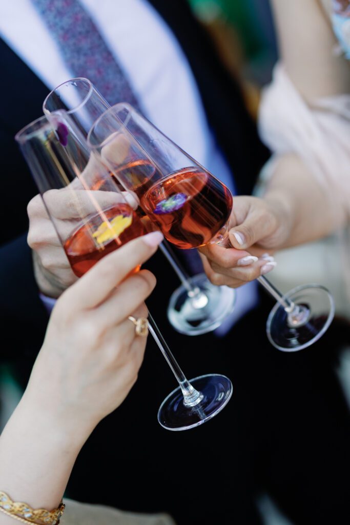 Wedding guests toasting with champagne glasses at Jacuzzi Winery celebration
