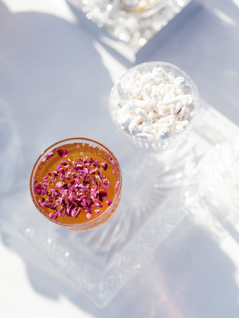 Signature wedding cocktail with floral garnish at Jacuzzi Winery reception
