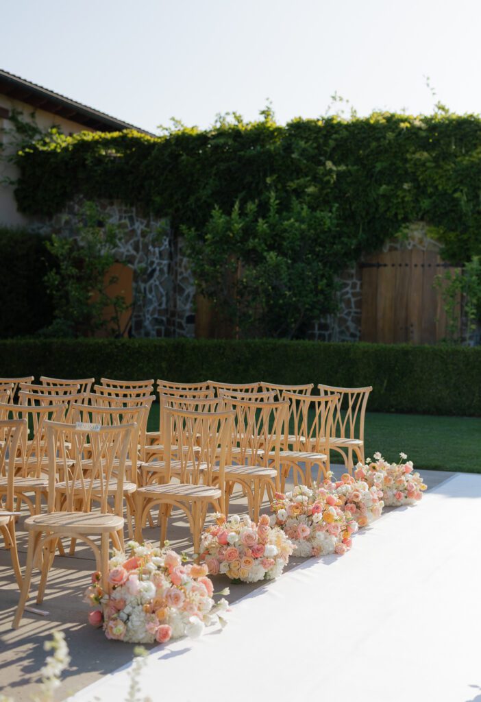 Outdoor wedding ceremony aisle with wooden chairs at Jacuzzi Winery in Sonoma
