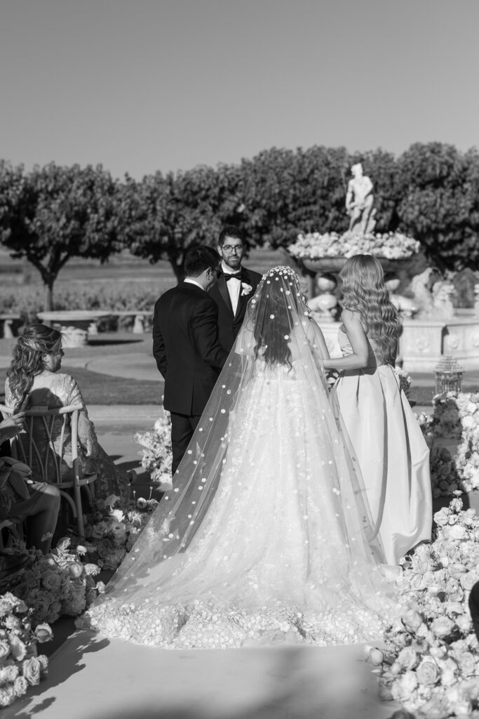 Black and white photo of bride and groom during outdoor ceremony at Jacuzzi Winery
