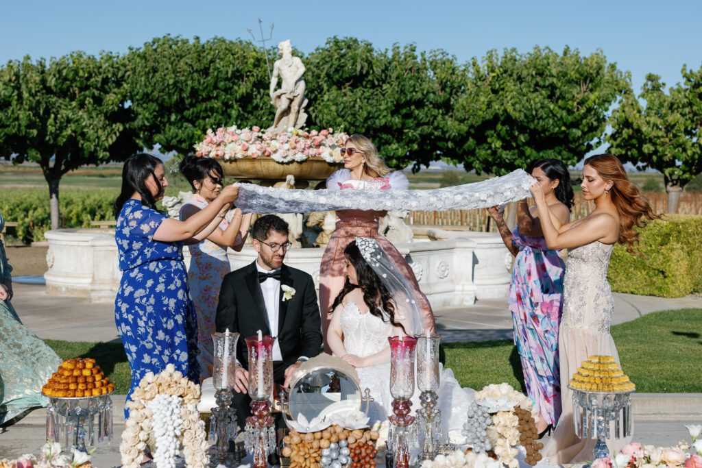 Bride and groom ceremony moment with veil lift at Jacuzzi Winery wedding
