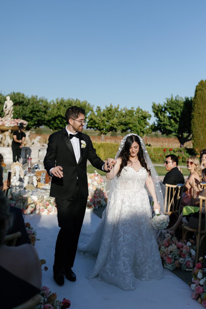 Bride and groom walking down the aisle after ceremony at Jacuzzi Winery
