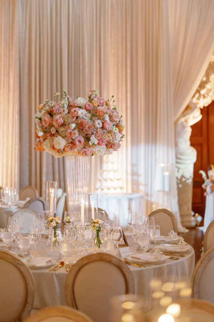 Tall wedding floral centerpiece designed by Florals by Hamid at elegant indoor reception
