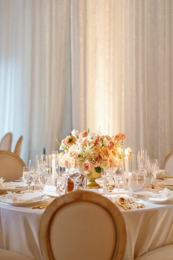 Wedding reception table with soft floral centerpiece by Florals by Hamid at Jacuzzi Winery

