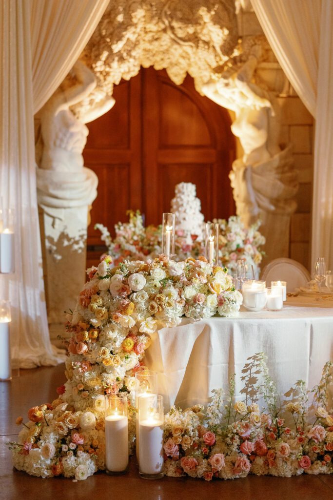 Wedding cake table surrounded by floral installation designed by Florals by Hamid at Jacuzzi Winery

