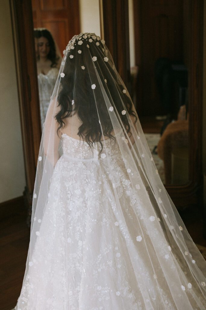 Bride wearing embroidered wedding veil during spring wedding at Jacuzzi Winery
